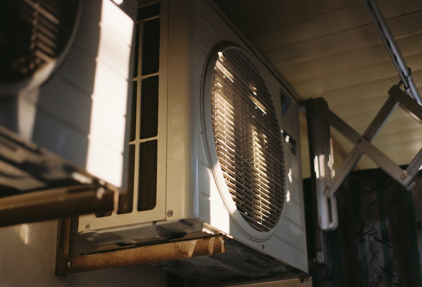 HVAC technician repairing an outdoor air conditioning condenser unit in Meridian, Idaho