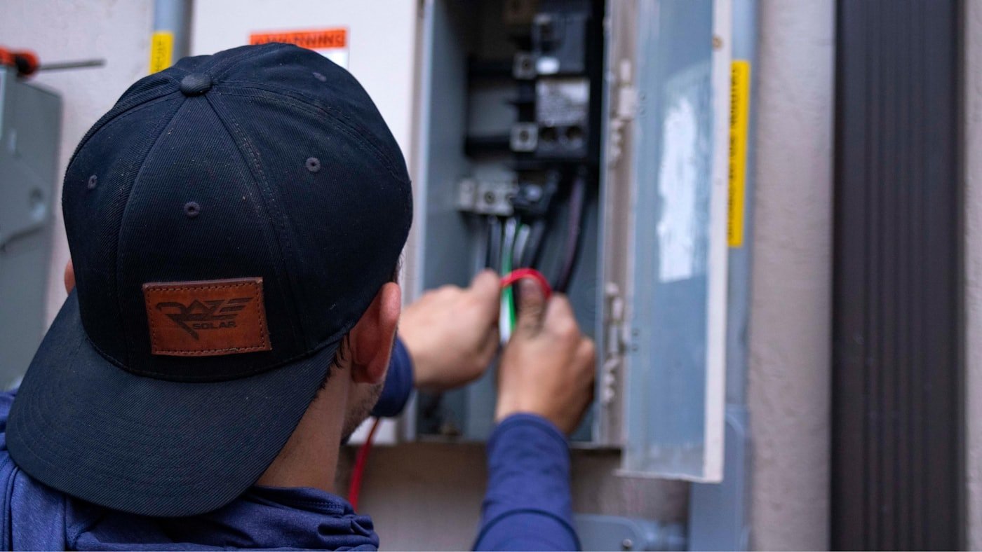 Electrician working on a residential breaker panel in a Meridian, Idaho home