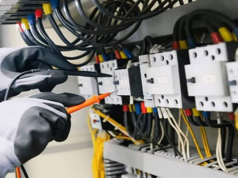 Licensed electrician working on a residential electrical panel in Meridian, Idaho