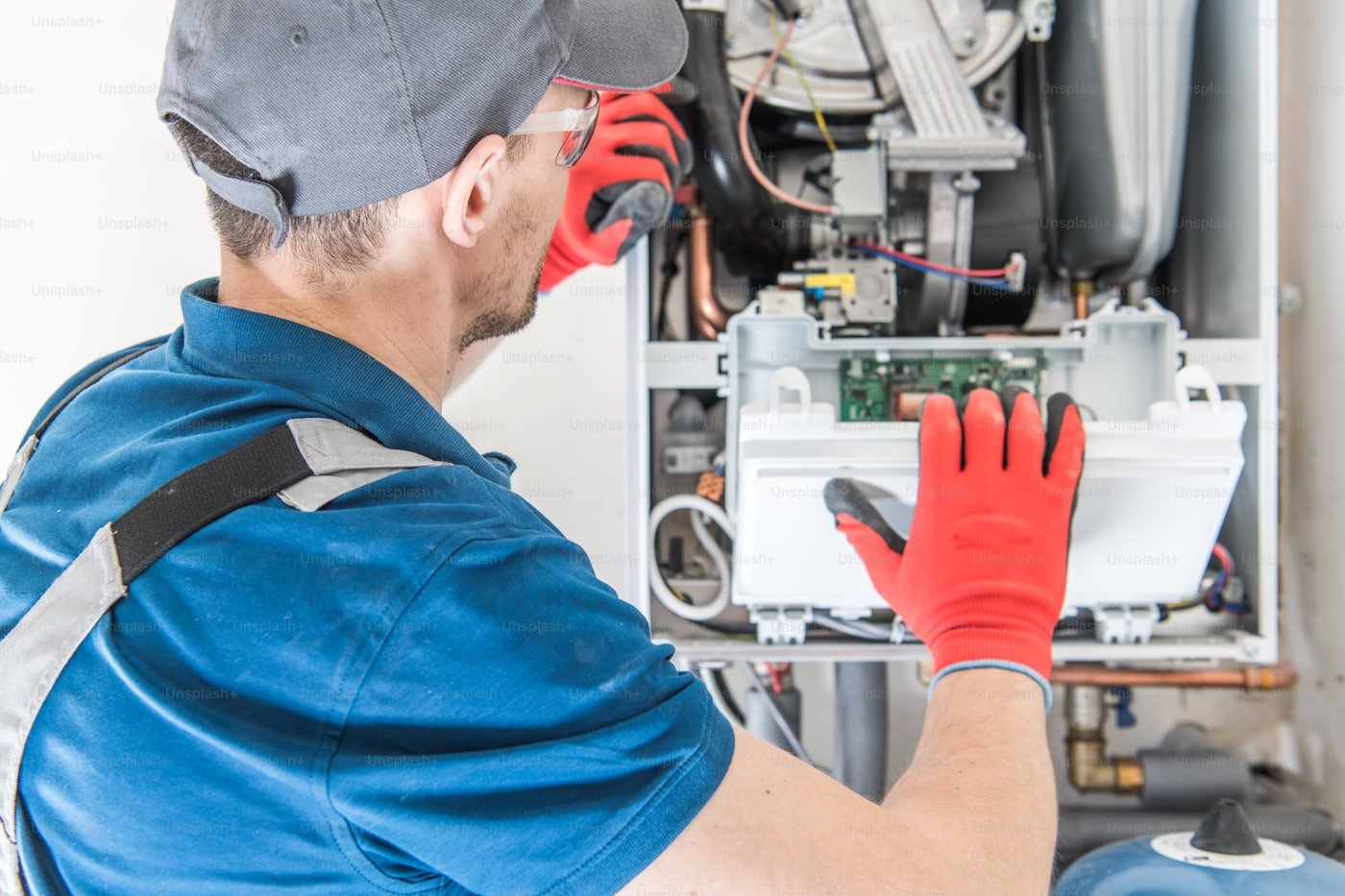 HVAC technician servicing a residential gas furnace in Meridian, Idaho