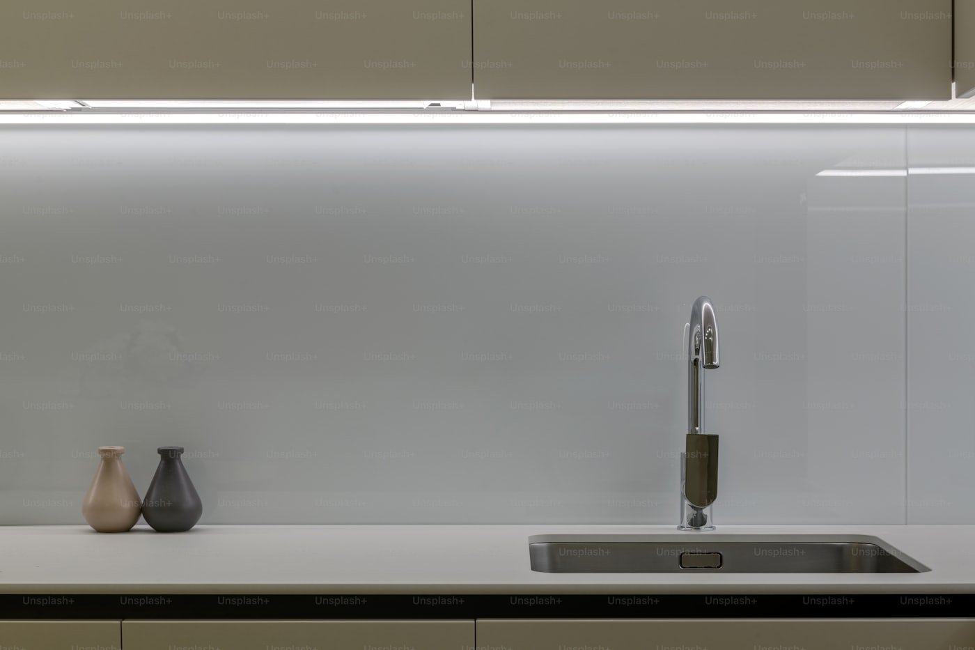 Plumbing connections under a kitchen sink including trap, disposal and dishwasher drain in a Meridian home