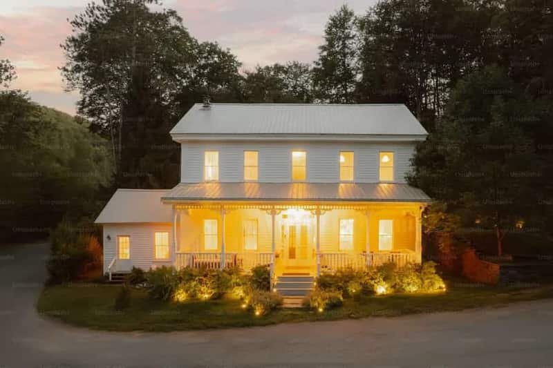 Landscape and patio lighting illuminating the exterior of a home in Meridian, Idaho at dusk