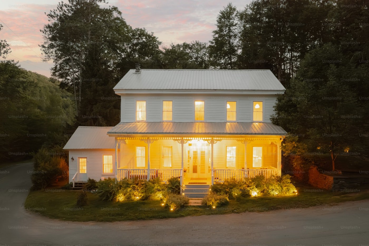 Landscape and patio lighting illuminating the exterior of a home in Meridian, Idaho at dusk