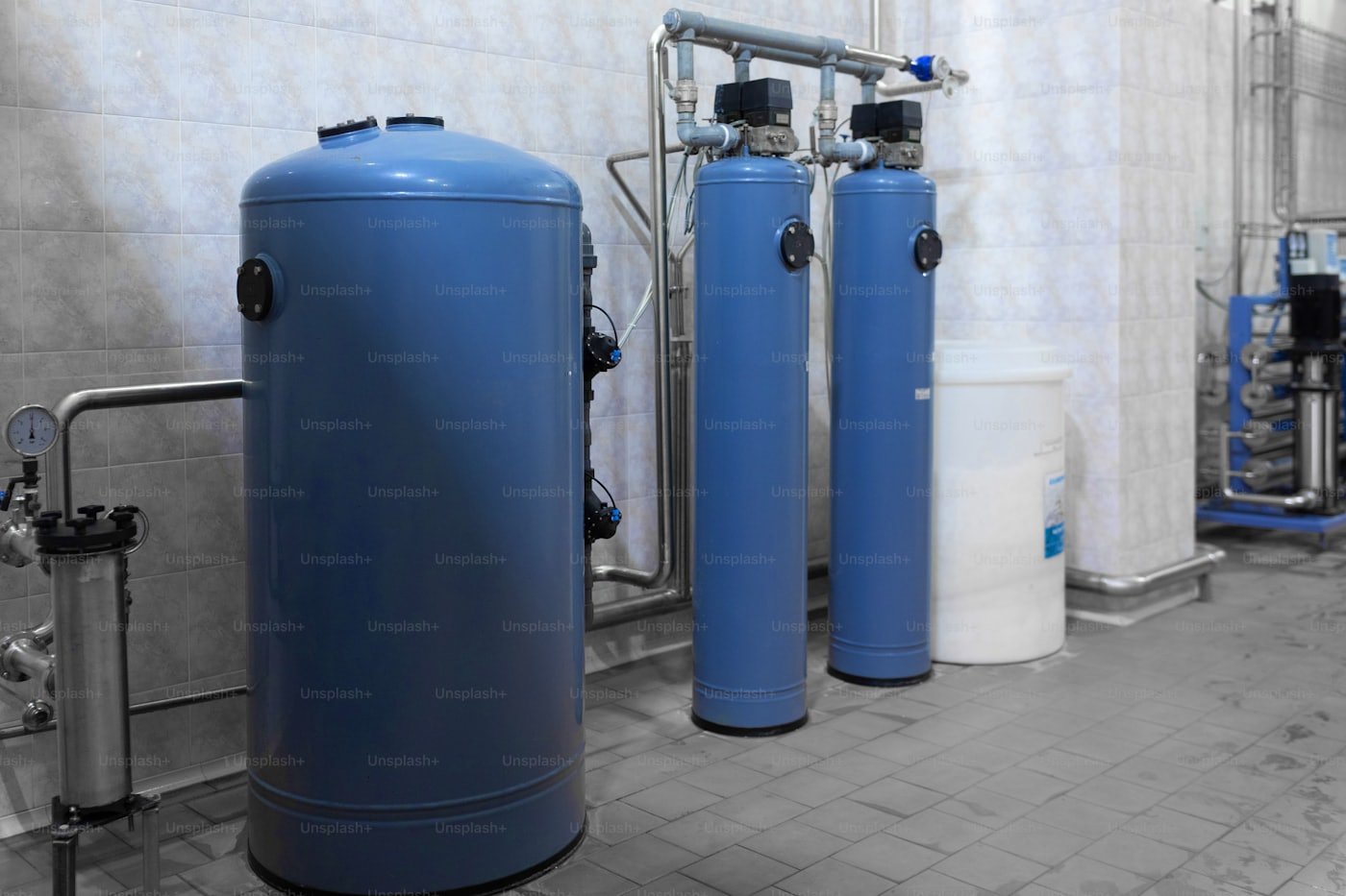 Plumber servicing a residential gas water heater in a Meridian, Idaho garage